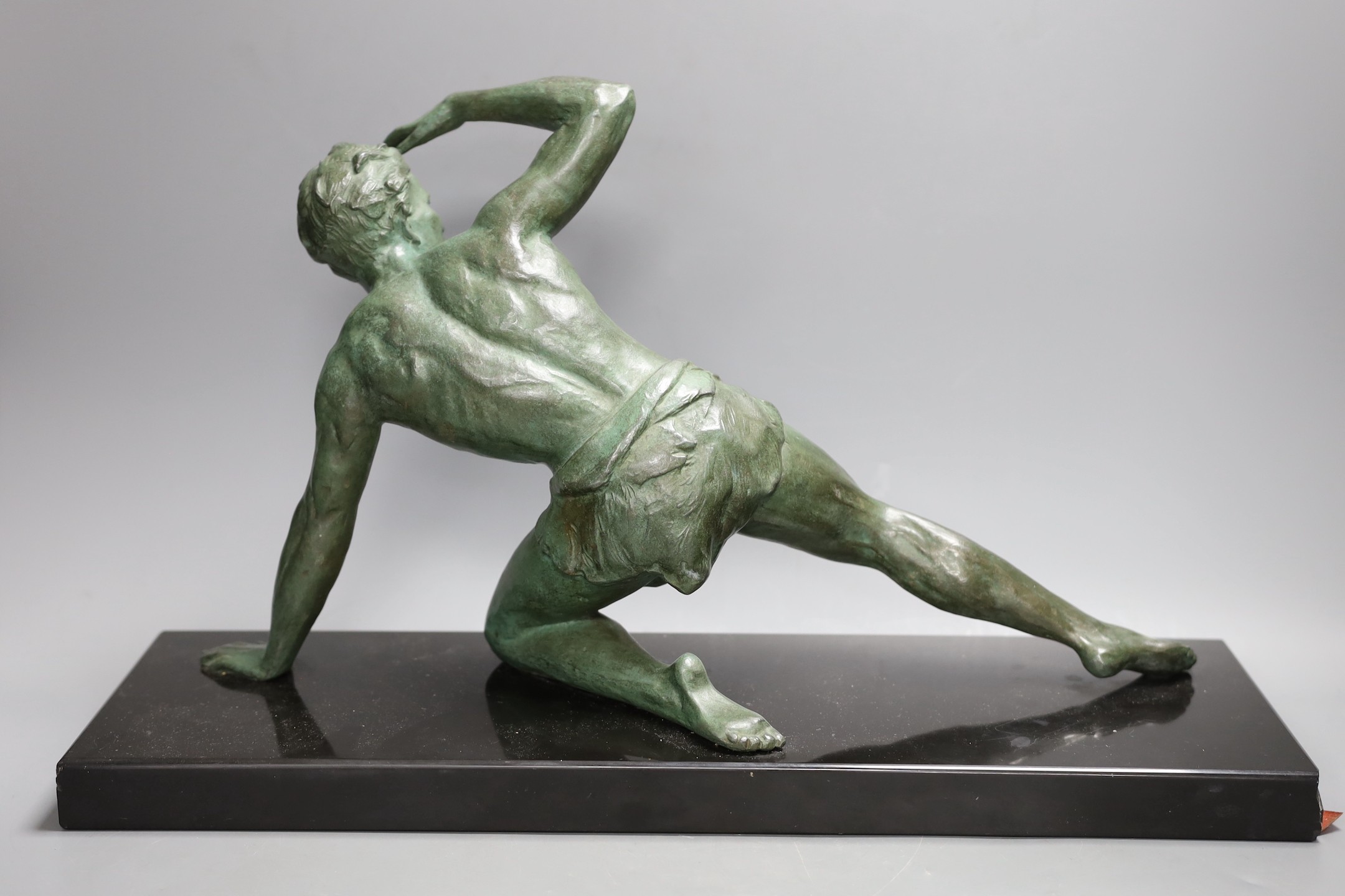 J. De Roncourt, bronze, of a reclining male on black marble stand, 49cms